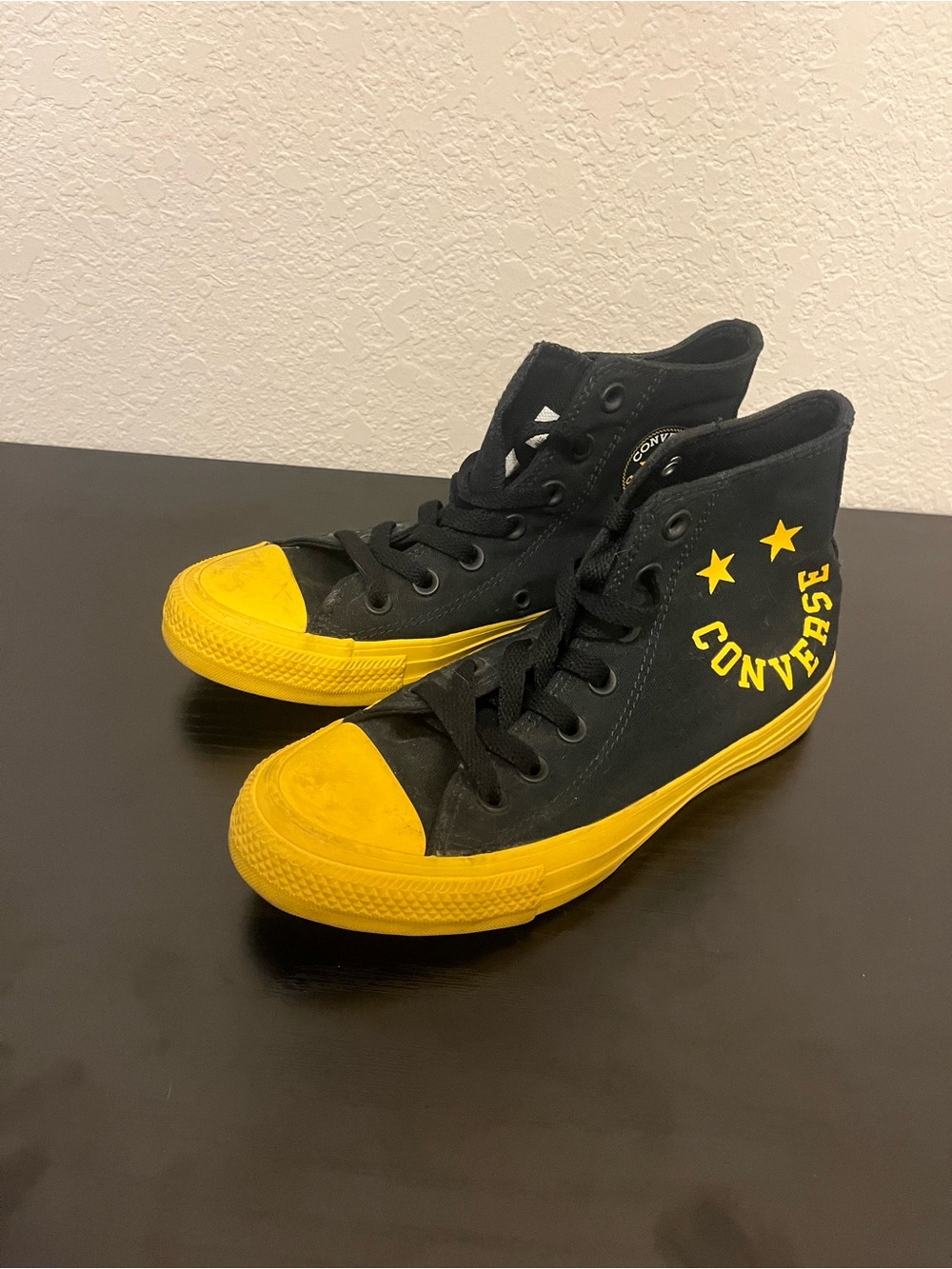 Smiley face black and yellow high top converse